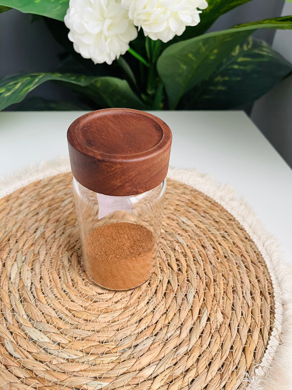 Single 300ml clear glass storage jar with a dark brown wooden lid standing on a white background