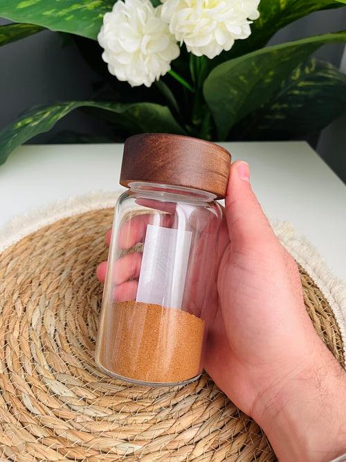 Single 300ml clear glass storage jar with a dark brown wooden lid standing on a white background