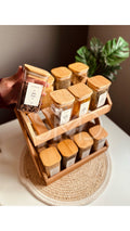 2-tier wooden spice rack organizer displaying 16 large 250ml glass jars on a kitchen counter
